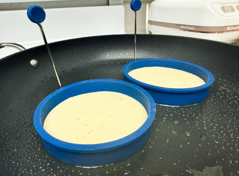 pancakes cooking in pancake ring.