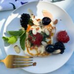 halloumi cheese salad with berries on a plate.