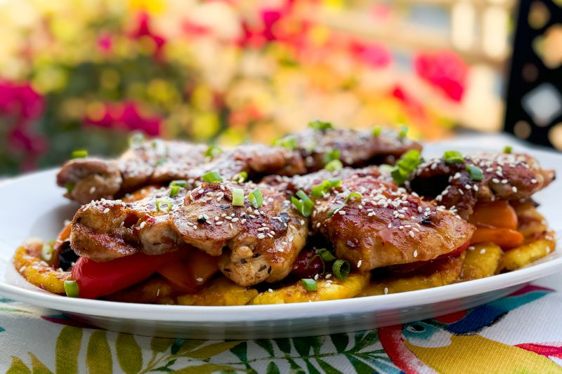 platter of huli huli chicken on peppers and pineapple.