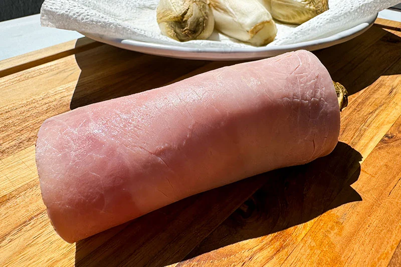 one head of endive wrapped in ham.