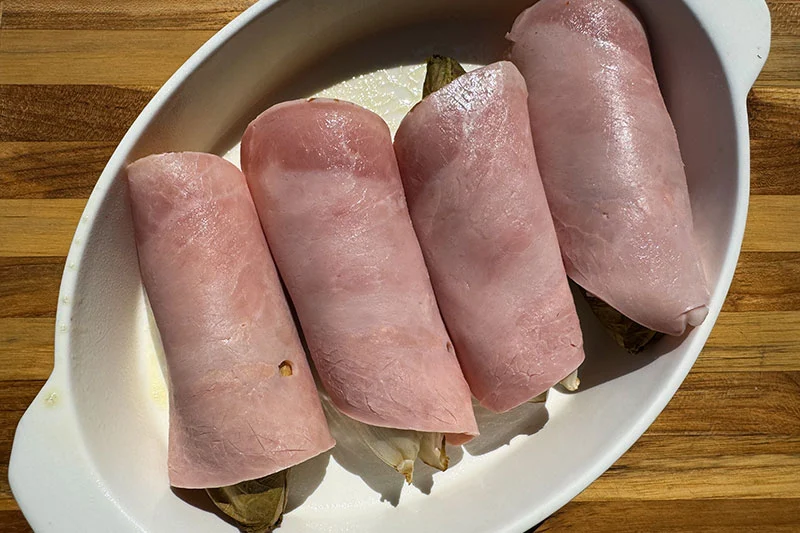 casserole dish with ham wrapped endive.