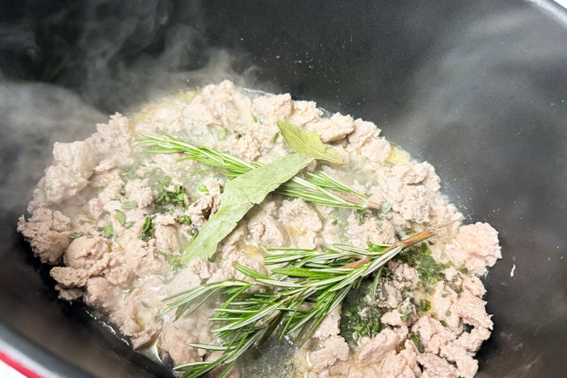 turkey sausage cooking with herbs.