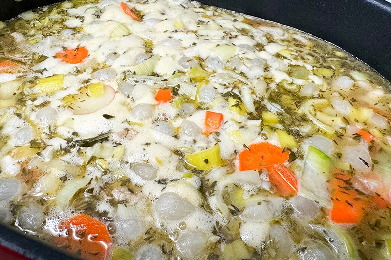 canellini bean and turkey soup cooking on stove.