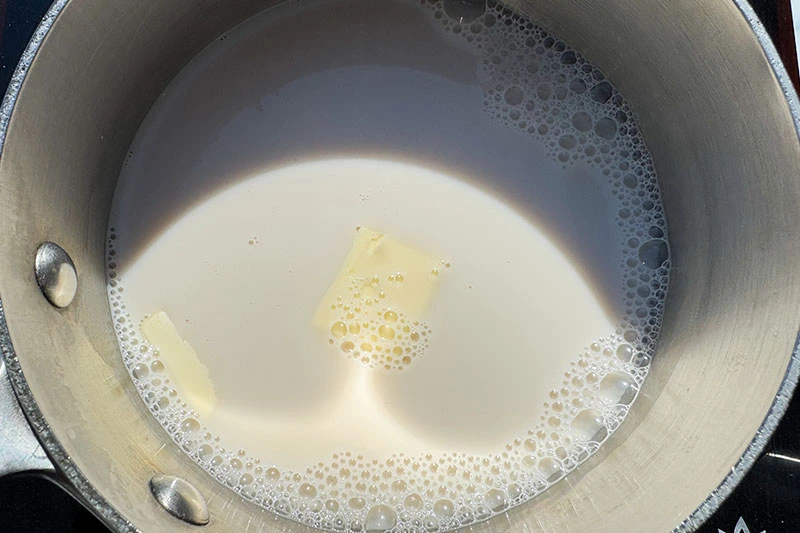 milk with butter in pot.