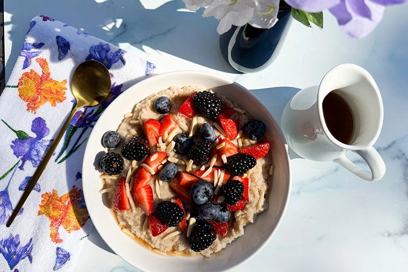 bowl of fonio cereal with almonds and berries.