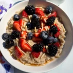 bowl of hot fonio cerea with berries and almonds.