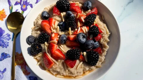 bowl of hot fonio cerea with berries and almonds.