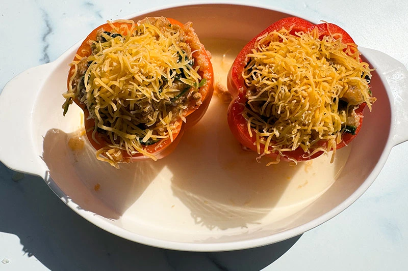 stuffed peppers in casserole dish ready for oven.