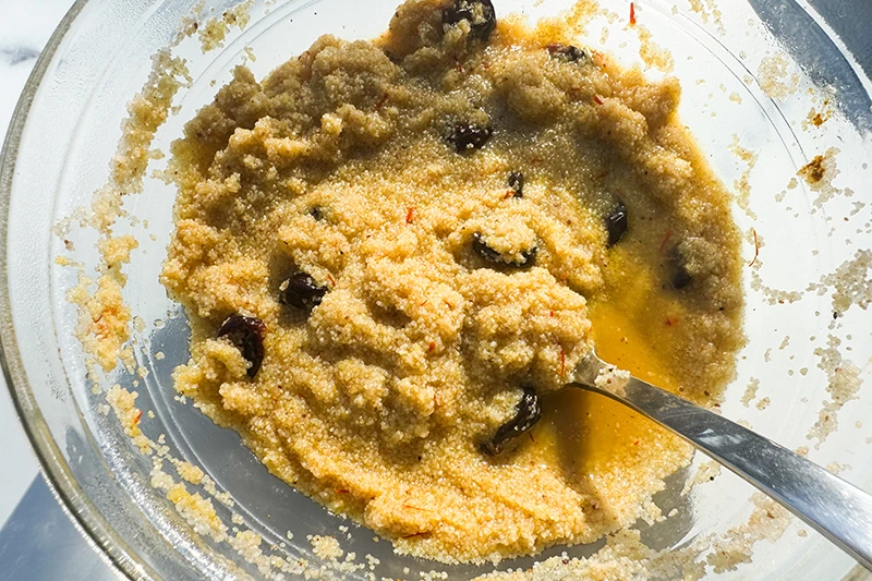 mixing Moroccan foniio in a bowl.