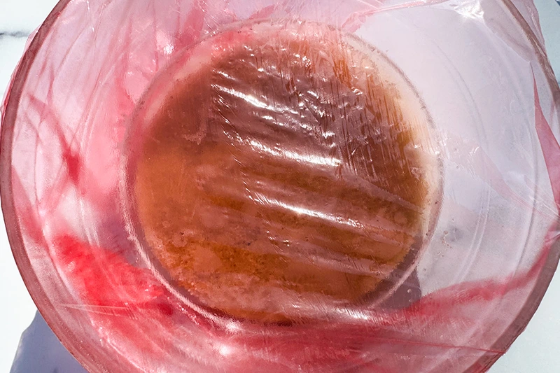 fonio in a bowl covered with plastic wrap.