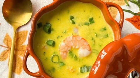 creamy corn, asparagus and shrimp soup in a bowl.