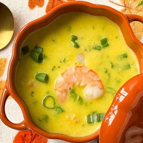 creamy corn, asparagus and shrimp soup in a bowl.