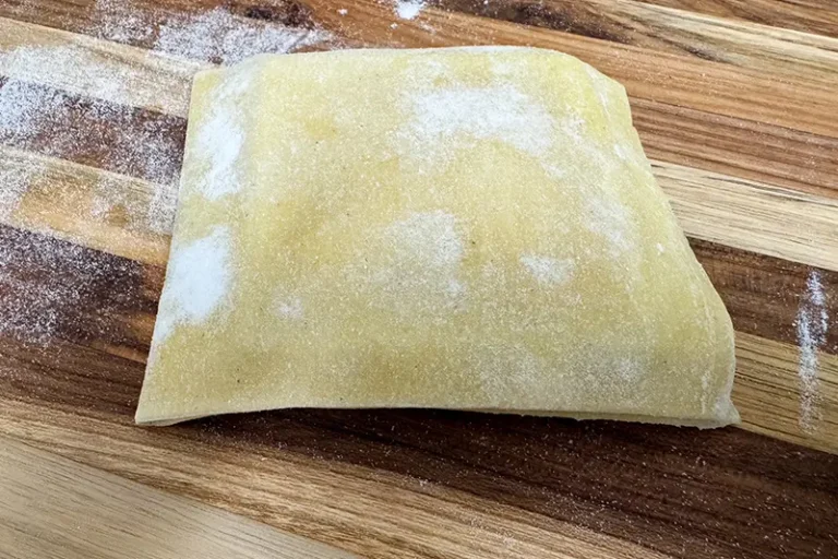 pasta folded over filling in ravioli mold.