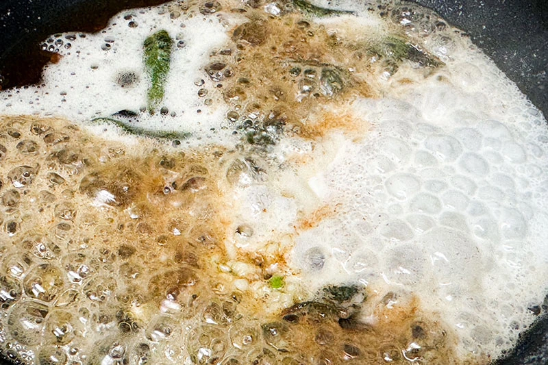 brown butter sauce with maple and sage cooking in skillet.