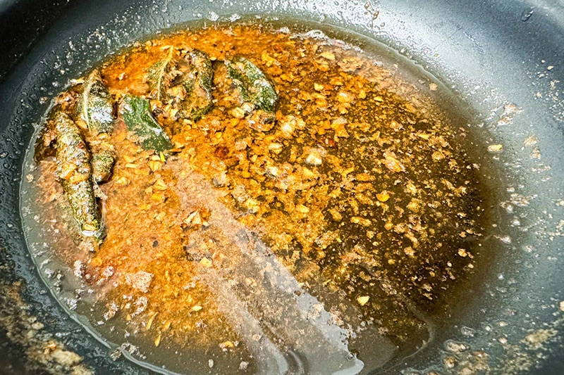 brown butter sauce with maple and sage cooking in skillet.