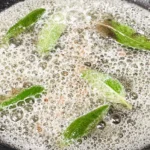 brown butter sauce with maple and sage cooking in a skillet.