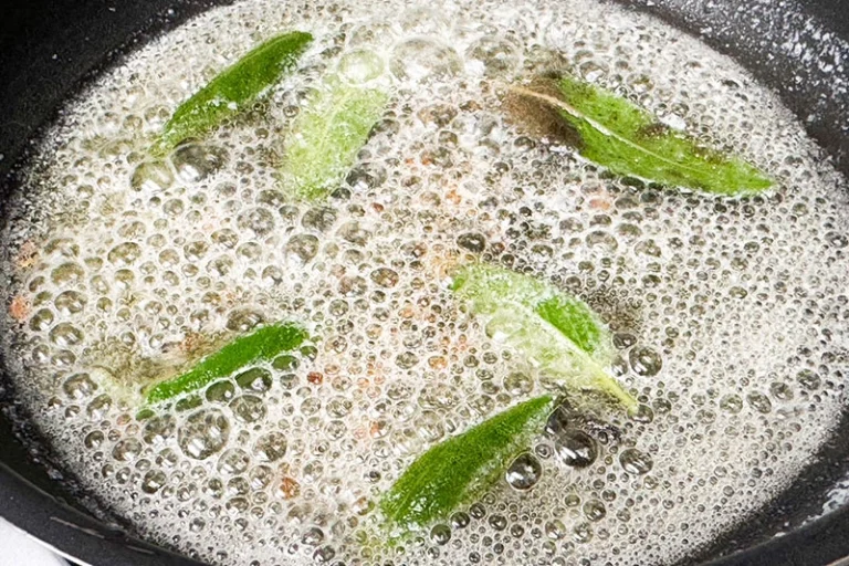 brown butter sauce with maple and sage cooking in a skillet.