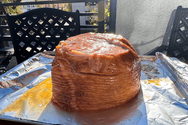 partially heated ham with first brush of glaze.