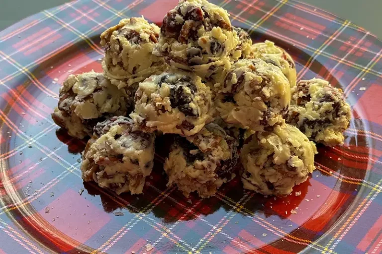 white chocolate, pecan and berry bites on a platter.