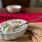 alaskan smoked salmon spread in a dish with knife.