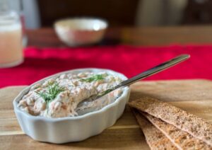 alaskan smoked salmon spread in a dish with knife.