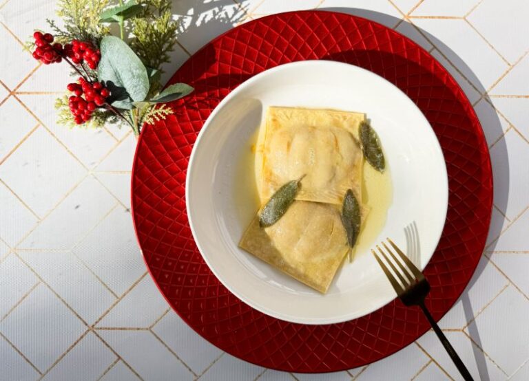 ricotta ravioli with pumpkin in butter maple sage sauce on a plate.