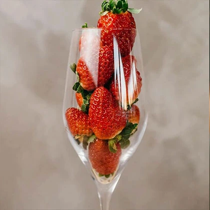 Champagne glass filled with strawberries.