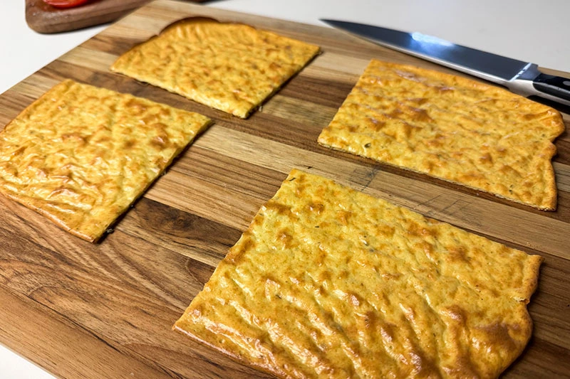 baked cottage cheese flatbread cut into four pieces.