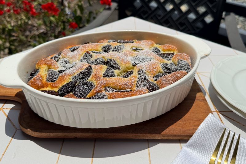 clafoutis aux prunes with powdered sugar.