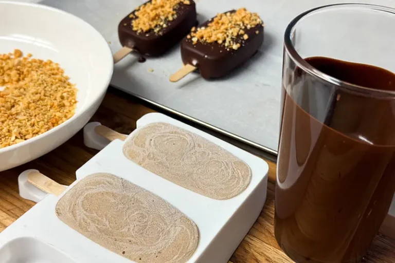 chocolate dipping station with chocolate, nuts and frozen pops.
