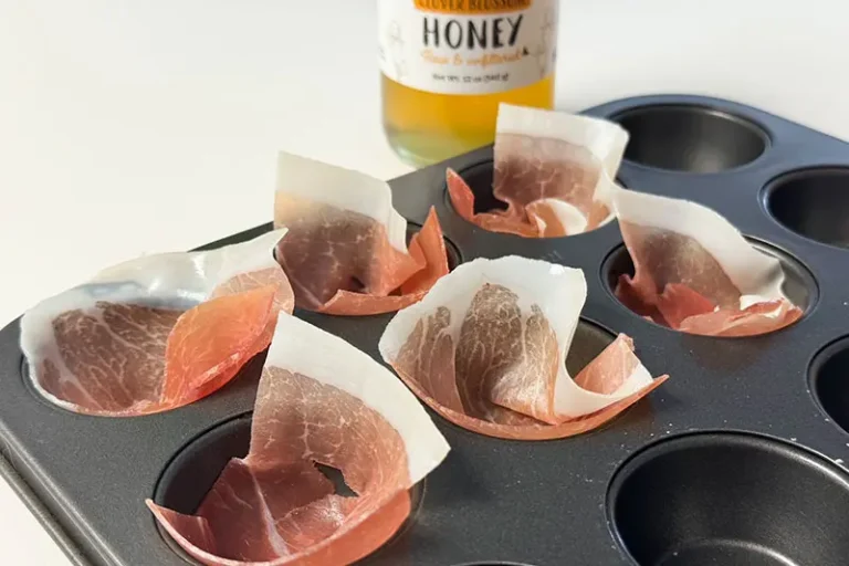 raw prosciutto in muffin cups.