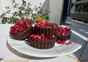 plate of dark chocolate pomegranate cups.