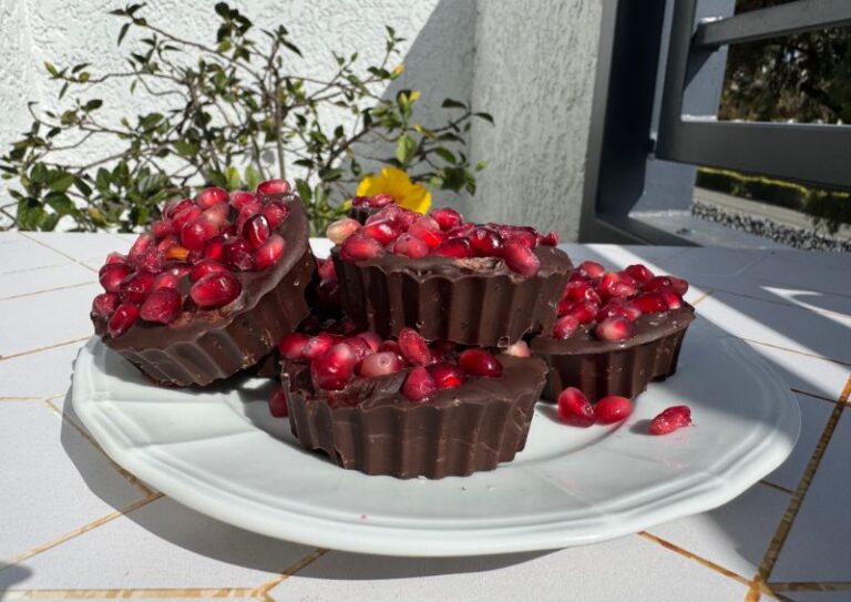 plate of dark chocolate pomegranate cups.