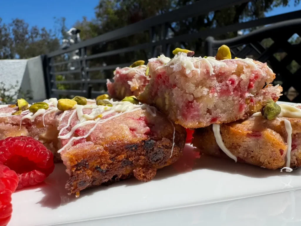 Close-up of delicious white chocolate raspberry blondes, topped with pistachios.