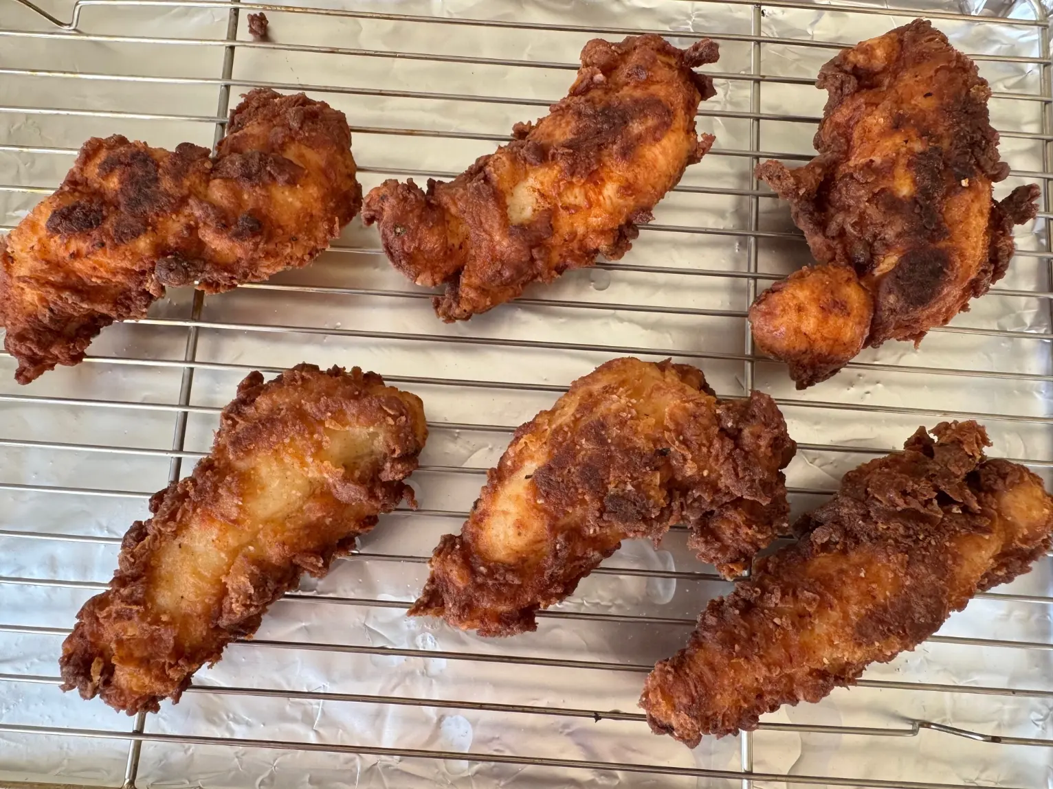 fried chicken tenders on a rack.