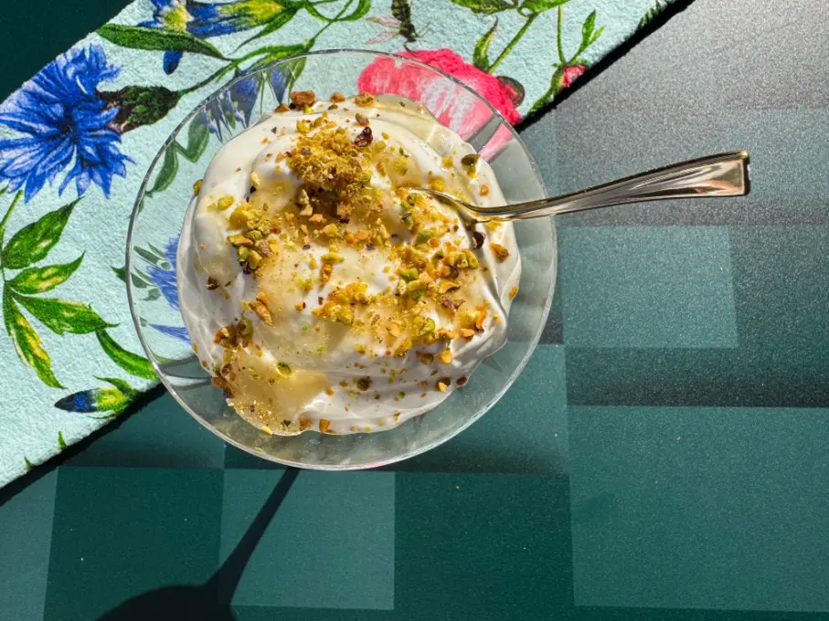 whipped Greek yogurt with honey and pistachios in a glass.