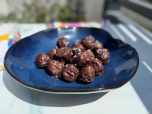 plate of sugar free high protein chocolate peanut butter balls.