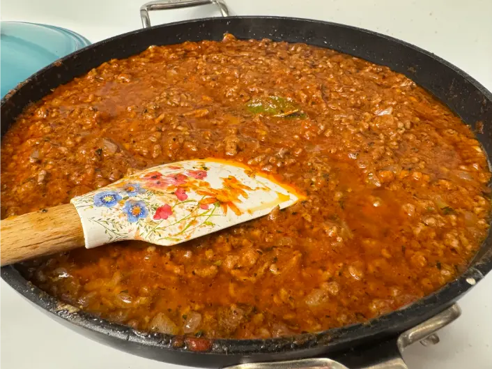 tomato meat sauce cooking in skillet.