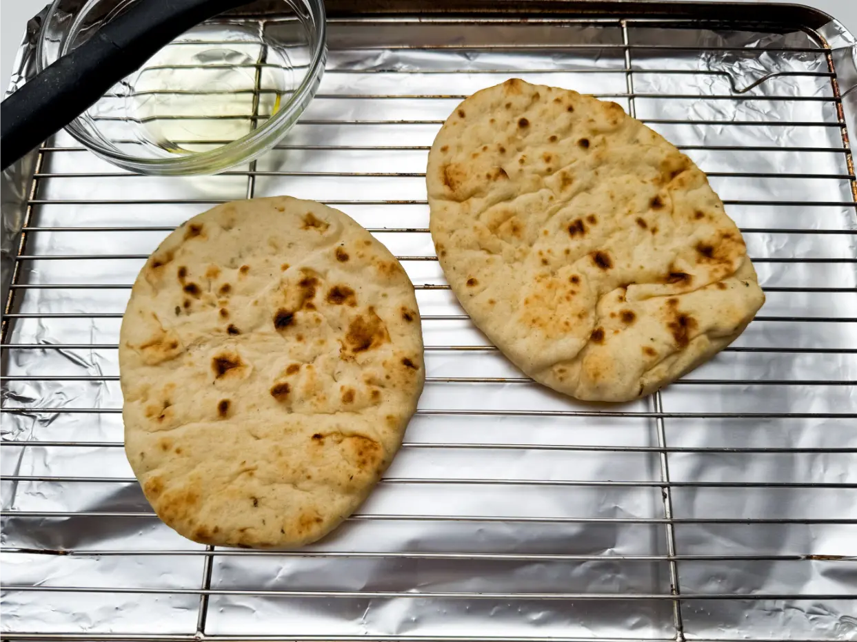 naan bread on baking sheet.